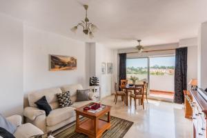 a living room with a couch and a table at Wonderful apartment 5 minutes flat walk to the Centre of La Cala de Mijas in La Cala de Mijas
