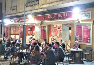 a group of people sitting at tables outside a restaurant at Immaculada Apartament Gandia in Gandía +16 photos