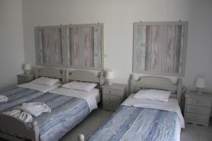 A bed or beds in a room at Kalypso Apartments