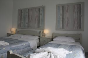 A bed or beds in a room at Kalypso Apartments