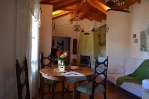 a dining room with a table and chairs and a room at Traditional Villa Nea Peramos in Nea Peramos