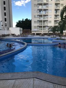 a swimming pool in a hotel with people in it at Prive Atrium Thermas Residence in Caldas Novas