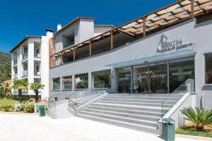 a building with stairs in front of it at Princess Golden Beach Hotel in Chrysi Ammoudia