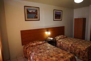 Säng eller sängar i ett rum på Hotel Santa Maria