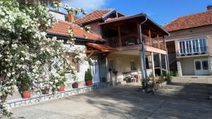 a house with a balcony and a patio at Guest House Green view in Pirot