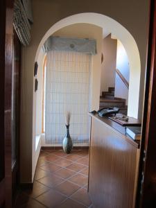 a kitchen with a hallway with a vase at Hotel Restaurante El Lago in Arcos de la Frontera