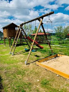 a playground with a slide and a swing at Pensjonat Sabina in Koszarawa