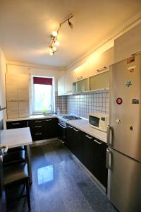 a kitchen with a refrigerator and a table in it at Bloc Izvor in Piteşti