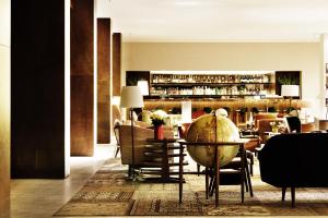 ベオグラードにあるSquare Nine Hotel Belgrade-The Leading Hotels of The Worldのテーブルと椅子のあるレストラン、バー
