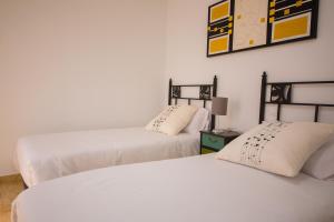 two beds sitting next to each other in a room at Calle Lanzarote 29C in Playa del Ingles
