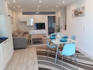 a kitchen and living room with a table and chairs at Ferienwohnung Villa Josephine in Badenweiler