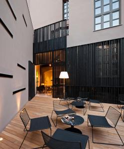 a lobby with chairs and tables and a building at Caro Hotel in Valencia
