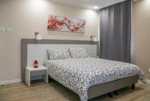 a bedroom with a bed and a painting on the wall at RED ONE in Maranello