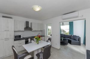 een keuken en een woonkamer met een tafel en stoelen bij Villa Ivan in Trogir