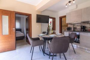 a kitchen and dining room with a table and chairs at Apartments Edi & Tea in Malinska