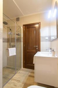 a bathroom with a sink and a shower with a door at Apartments Edi & Tea in Malinska +73 photos