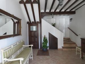 a hallway with benches and stairs with a mirror at Villa Elisa Plaza Mayor in Chinchón