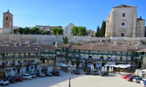 a city with cars parked in a parking lot at Villa Elisa Plaza Mayor in Chinchón