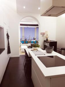 a kitchen with a counter and a living room at Brugmann Loft Apartment in Brussels