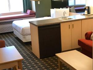a hotel room with a bed and a desk at Mariner's Village Resort in Carlyle
