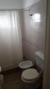 a bathroom with a white toilet and a sink at Bagu Playa Grande Hotel in Mar del Plata +77 photos