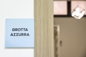 a sign on a door in front of a building at Bed and Breakfast Porto Flavia in Iglesias