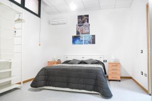 a bedroom with a bed with a black blanket at Bed and Breakfast Porto Flavia in Iglesias