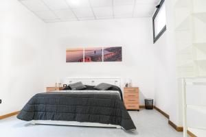 a bedroom with a bed with a black blanket at Bed and Breakfast Porto Flavia in Iglesias