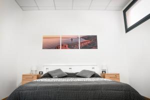 a bedroom with a bed and a picture on the wall at Bed and Breakfast Porto Flavia in Iglesias