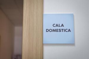 a sign that says cala dominica on a door at Bed and Breakfast Porto Flavia in Iglesias