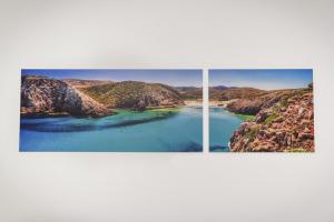 two photographs of a river and mountains on a wall at Bed and Breakfast Porto Flavia in Iglesias