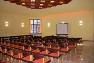 an empty room with a lecture hall with chairs and a screen at Apart Hotel Central Razgrad in Razgrad