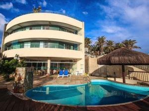 a building with a swimming pool in front of a building at Residence Vespucci in Natal
