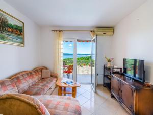 a living room with a couch and a television at Apartment Nenad in Dramalj