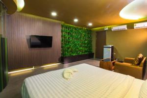 a hotel room with a bed and a tv and a bed sidx sidx at Sweety Resort in Bangna +55 photos