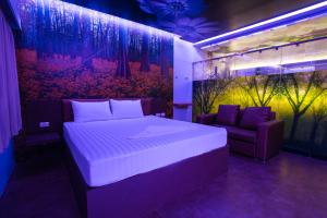 a bedroom with a large bed and a couch at Sweety Resort in Bangna