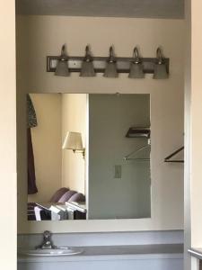 a mirror in a room with a bed and lights at Salt Creek Inn in Nashville +32 photos