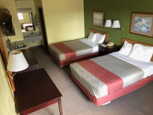 a hotel room with two beds and a table at Salt Creek Inn in Nashville