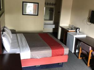 a hotel room with a bed and a sink at Salt Creek Inn in Nashville