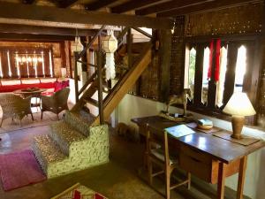 a living room with a table and a desk at Sang Tong Huts in Mae Hong Son