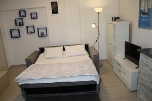 a bedroom with a bed and a flat screen tv at Holiday Home Radmila in Premantura