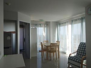a kitchen and dining room with a table and chairs at Grandbeach Condo Sea view by malai in Mae Pim