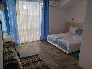 Postel nebo postele na pokoji v ubytování Guest House Evtimov