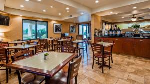 a restaurant with tables and chairs and a bar at Best Western Exeter Inn & Suites in Exeter