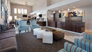 a lobby with couches and chairs and a bar at Best Western Apricot Inn in Chaney Ranch