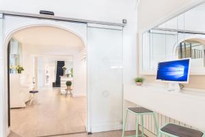 a living room with a desk with a computer on a counter at FERGUS Style Soller Beach in Port de Soller