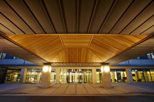 a large building with a wooden roof at night at Hotel Prumir in Hwaseong