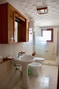 a bathroom with a sink and a toilet at De Amicis Apartment in Cagliari