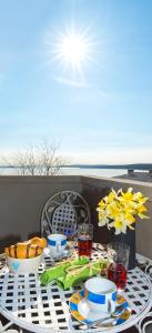 a table with a plate of food on a table at Apartment Stefania on the beach in Koromačno