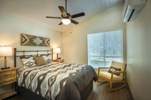 a bedroom with a bed and a fan and a chair at 11R Spring Meadow Retreat in Wawona